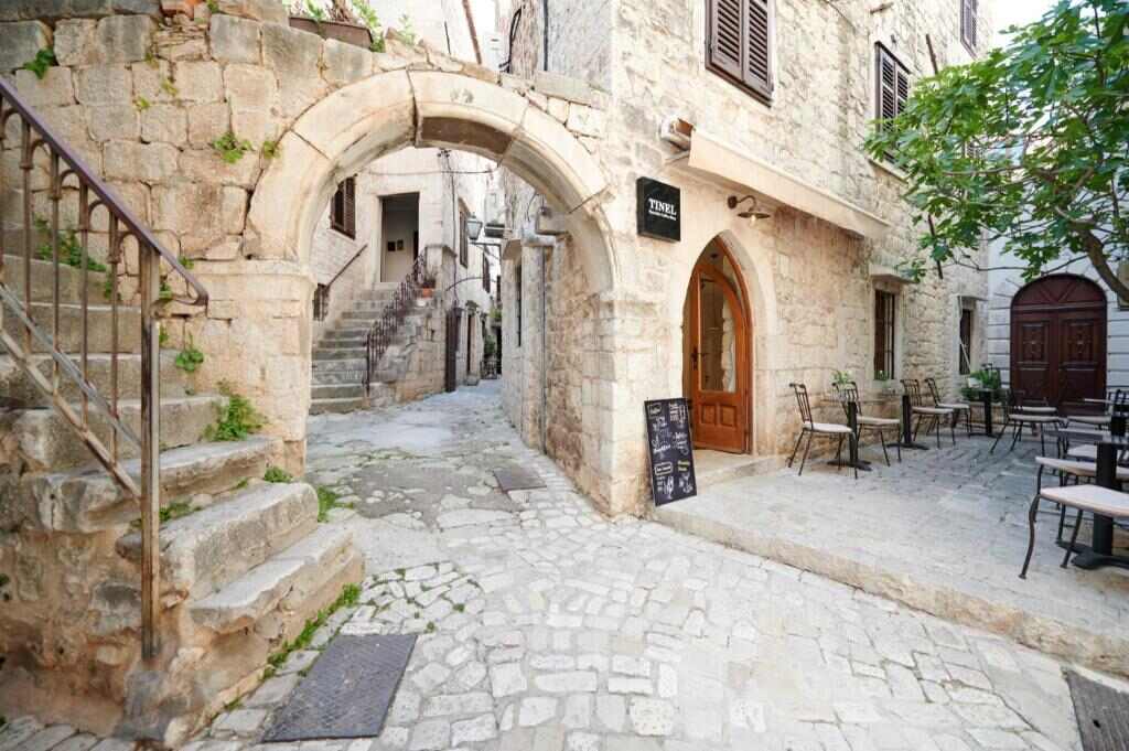 Stone streets of Trogir Old Town by Palace Derossi